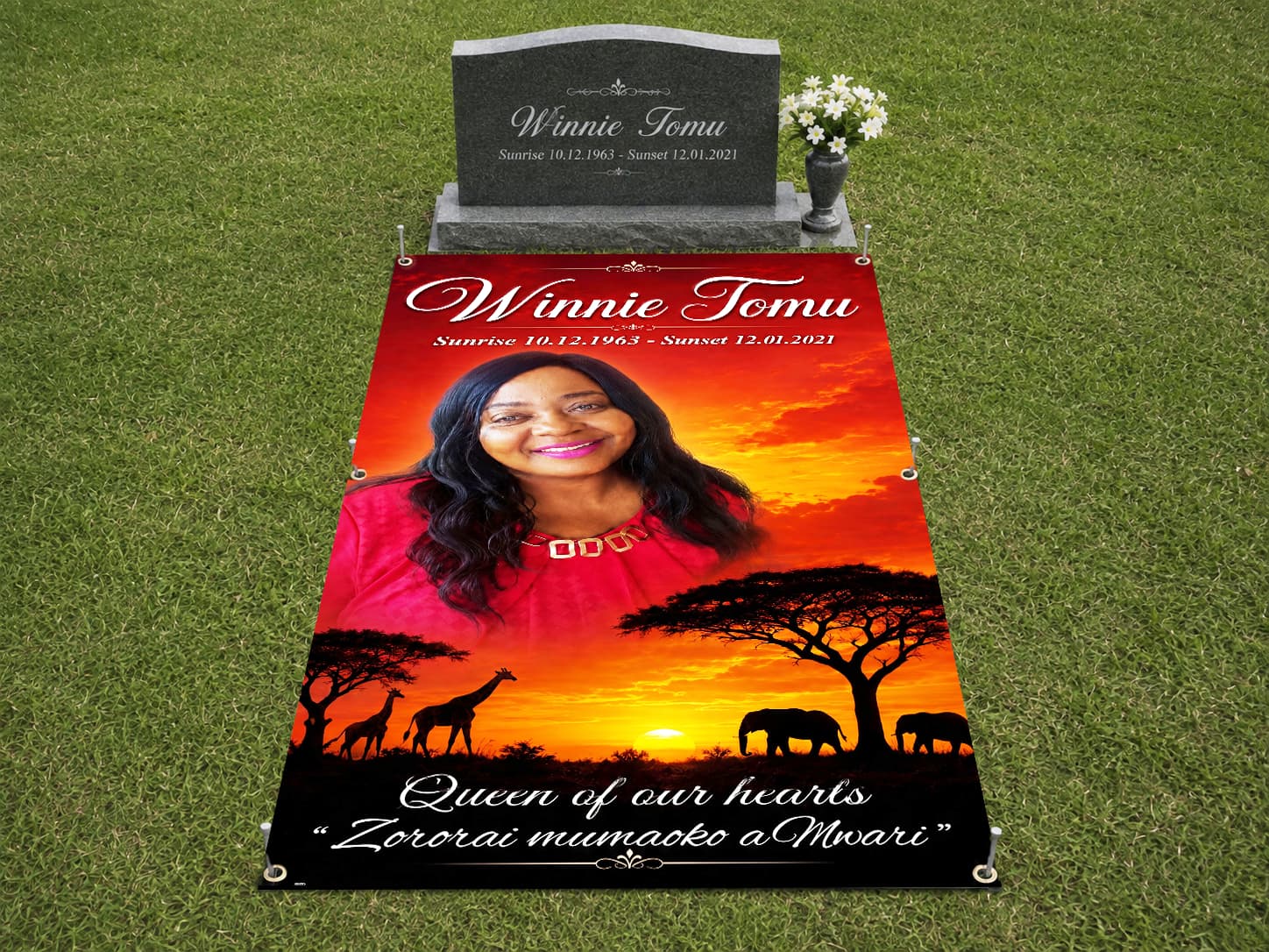 A personalised memorial grave cover secured flat at a graveside