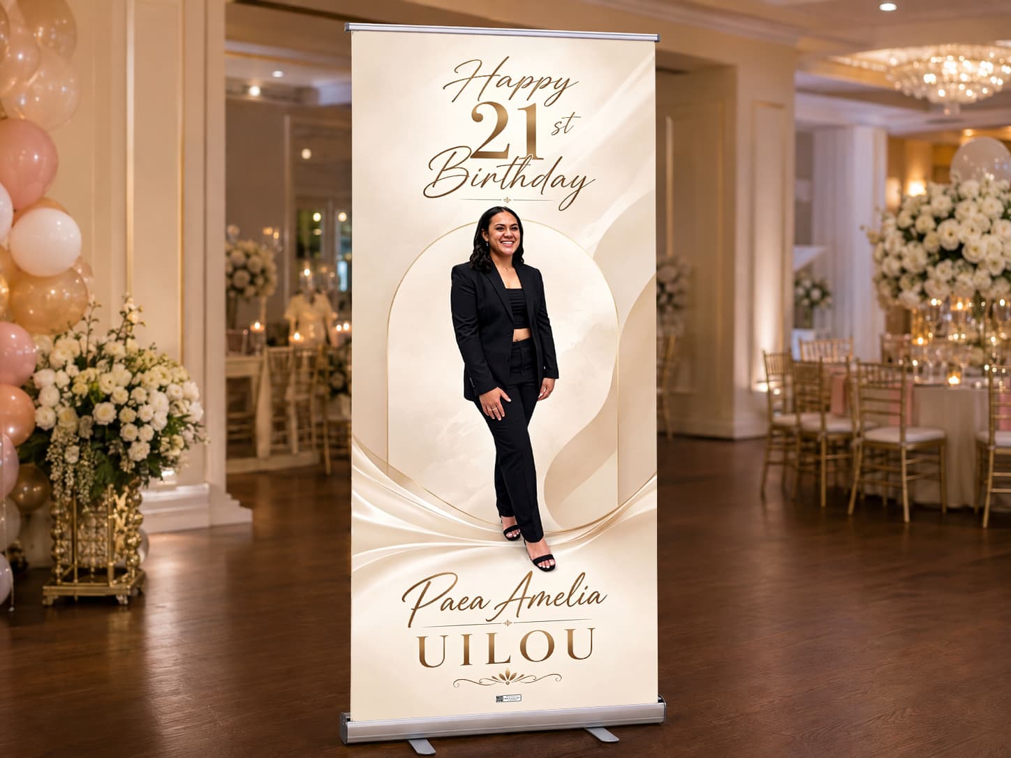 A personalised 21st birthday roll-up banner standing on its complete display base